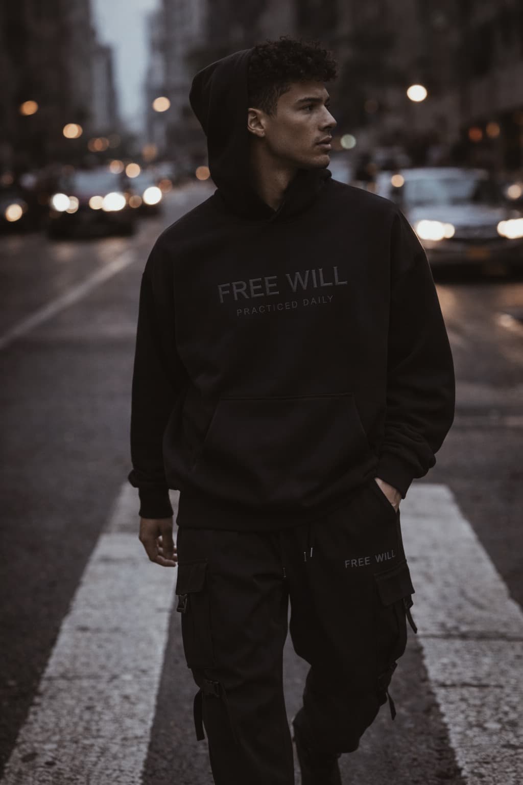 Free Will model wearing black hoodie in the city